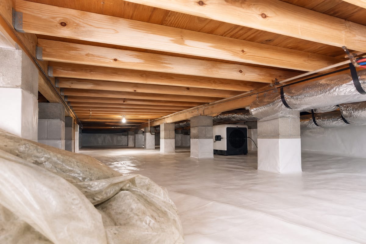 Crawl space mold cleanup area with treated joists and clean liner in McDonough GA
